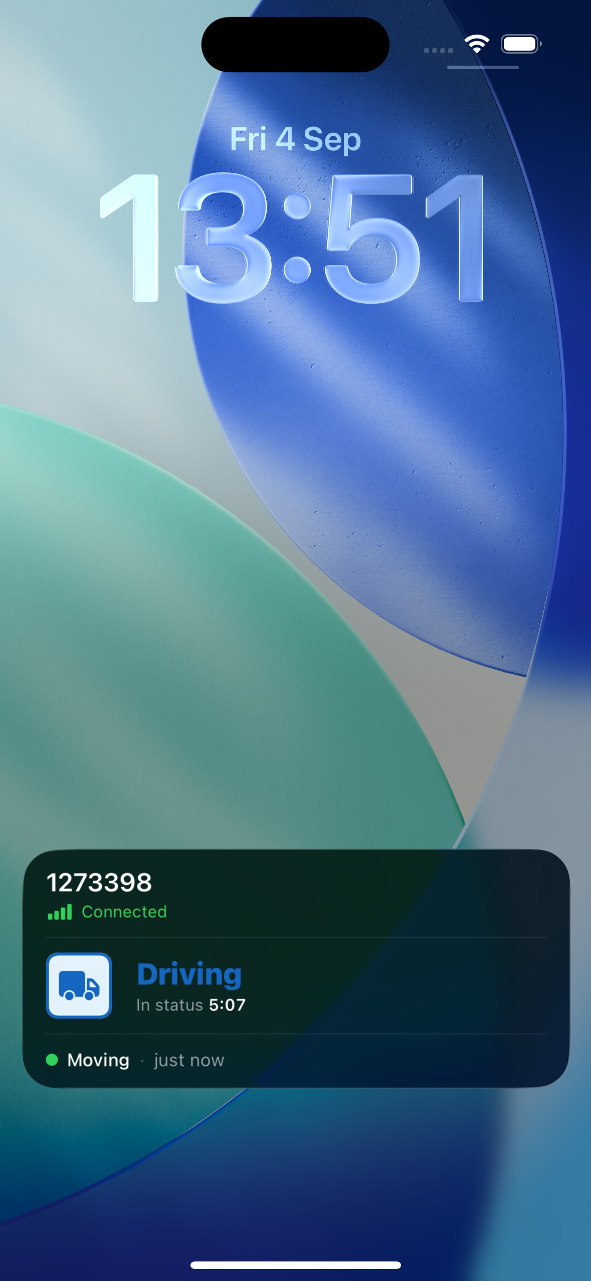 iPhone lock screen showing the E-Logs Live Activity card: vehicle 1273398 marked Connected, a Driving badge with In status 5:07, and a Moving motion row updated just now