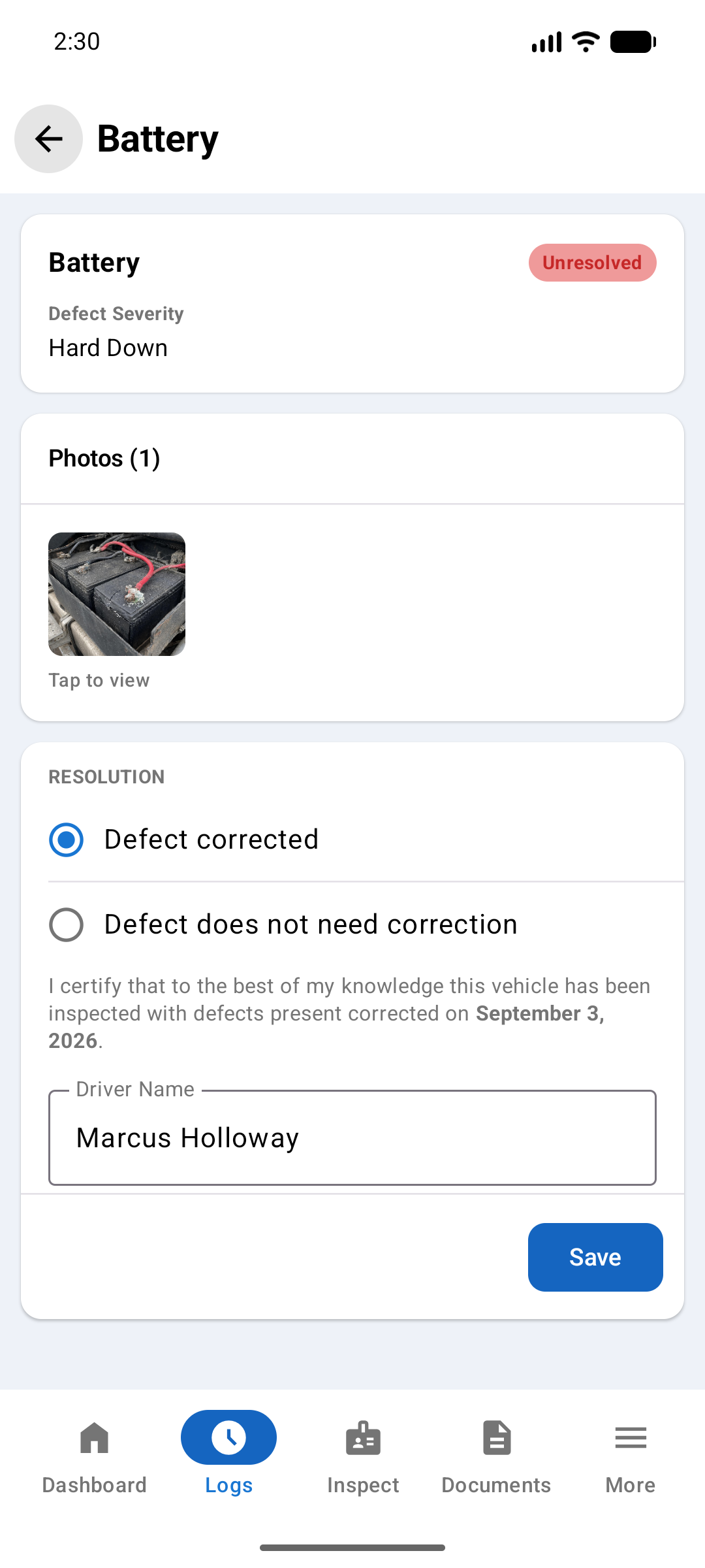 Battery defect screen showing severity Hard Down, an attached photo, and a Resolution section with Defect corrected selected, the certification wording, a driver name field, and a Save button
